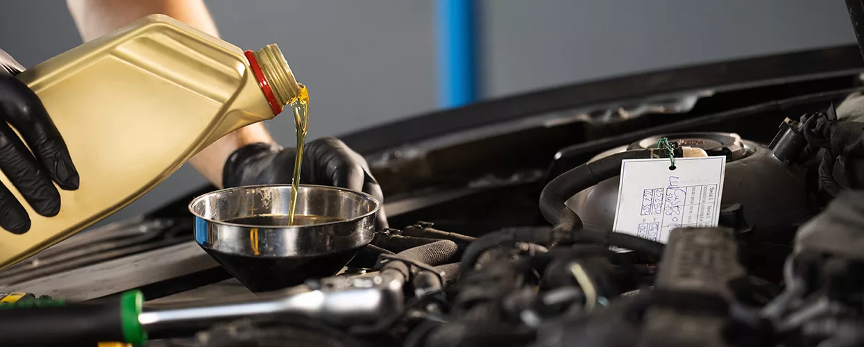 pouring oil into engine