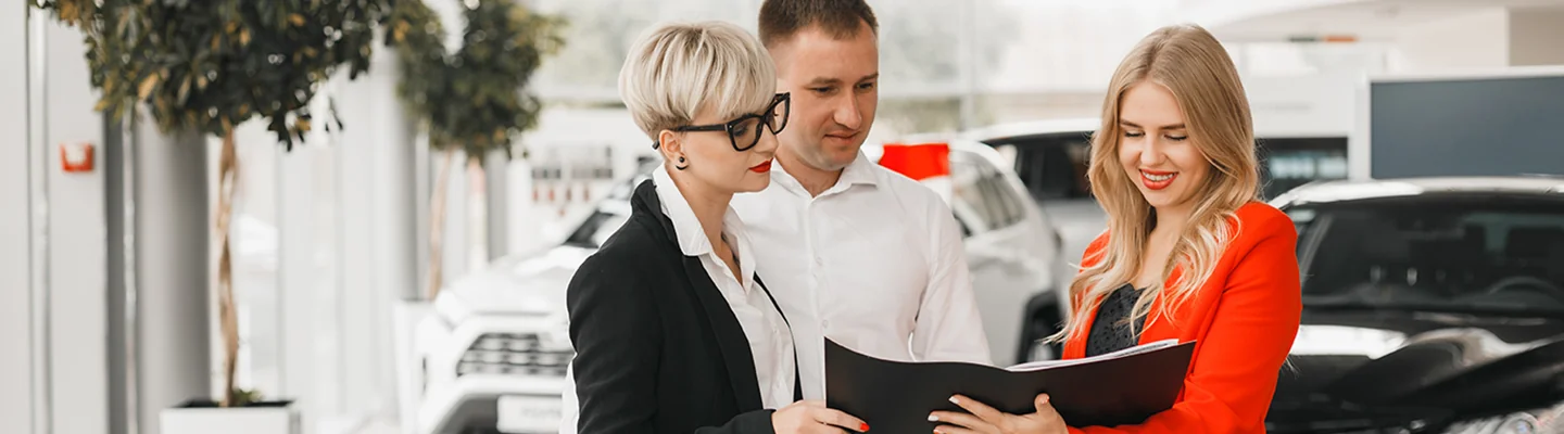 sales woman showing a husband and wife a contract