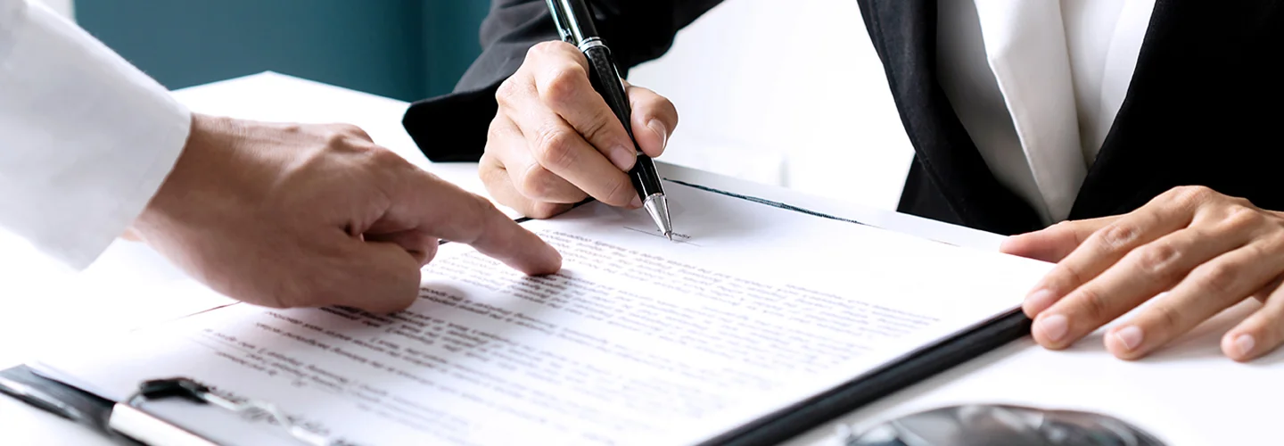 two people hands goig over contract for a new Mini