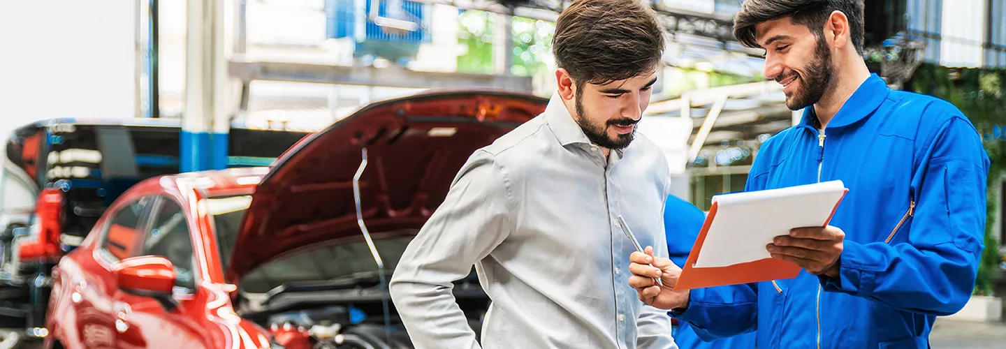Service technician showing a customer information about their vehicle