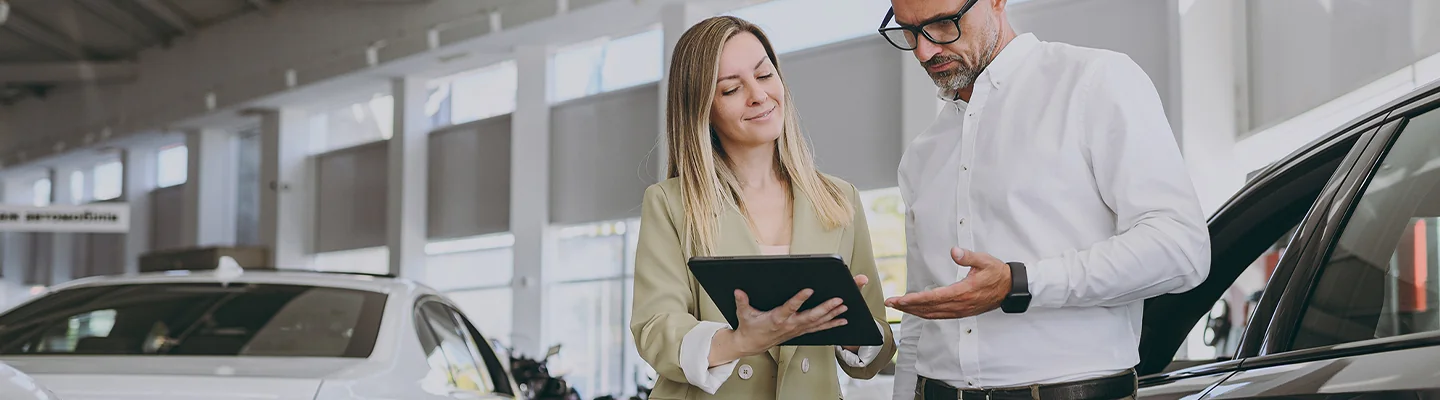 two people discussing details of a Certified Pre-Owned Mercedes-Benz purchase