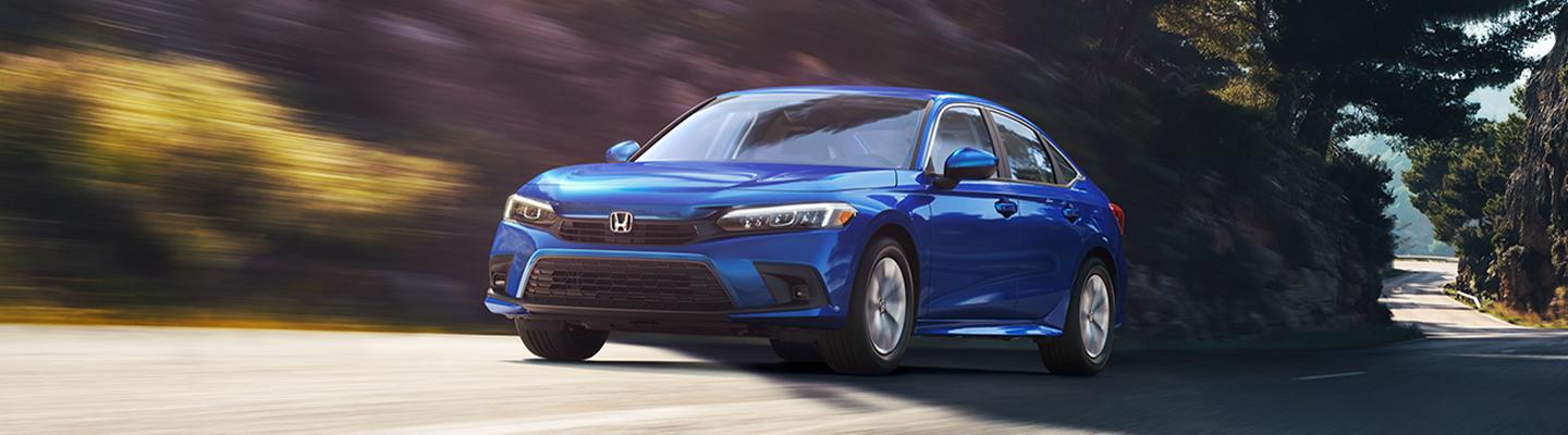 Angled profile of a blue Honda Civic in motion