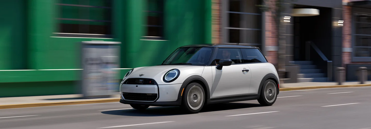 a white Certified Pre-Owned MINI in motion