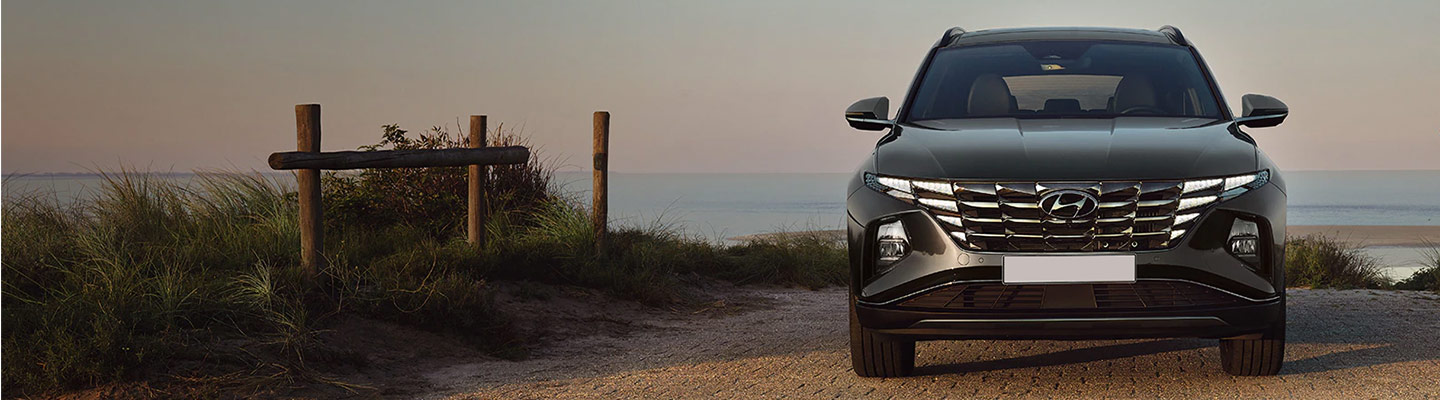A black Hyundai Tucson parked overlooking a body of water
