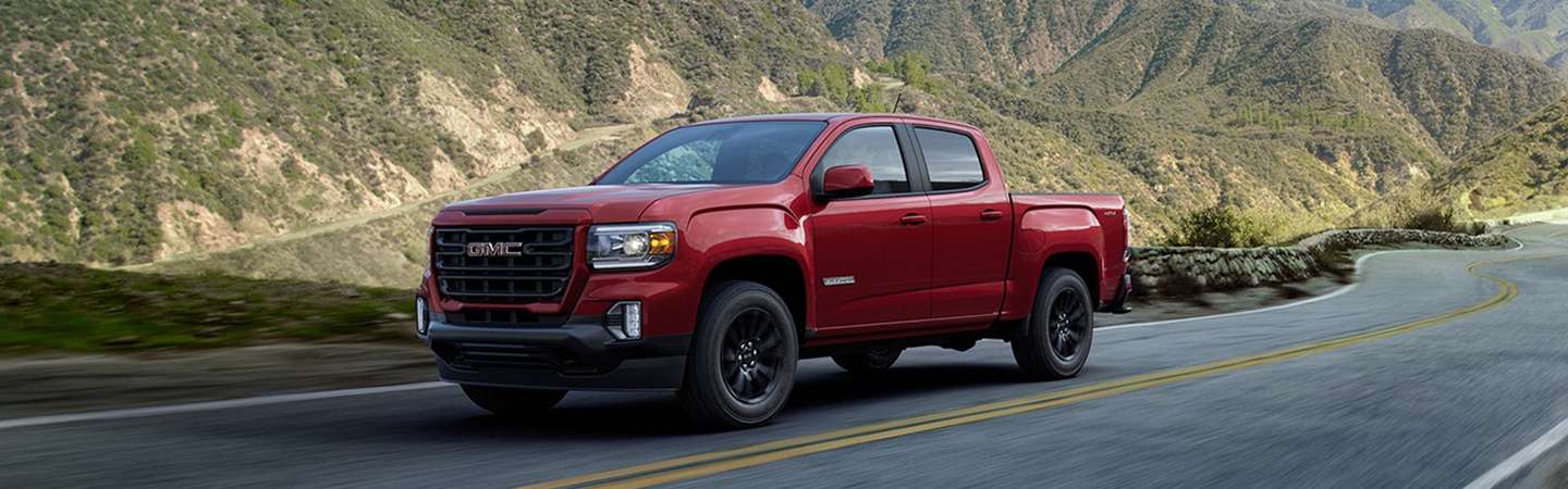 Red 2022 GMC Canyon drving on a road