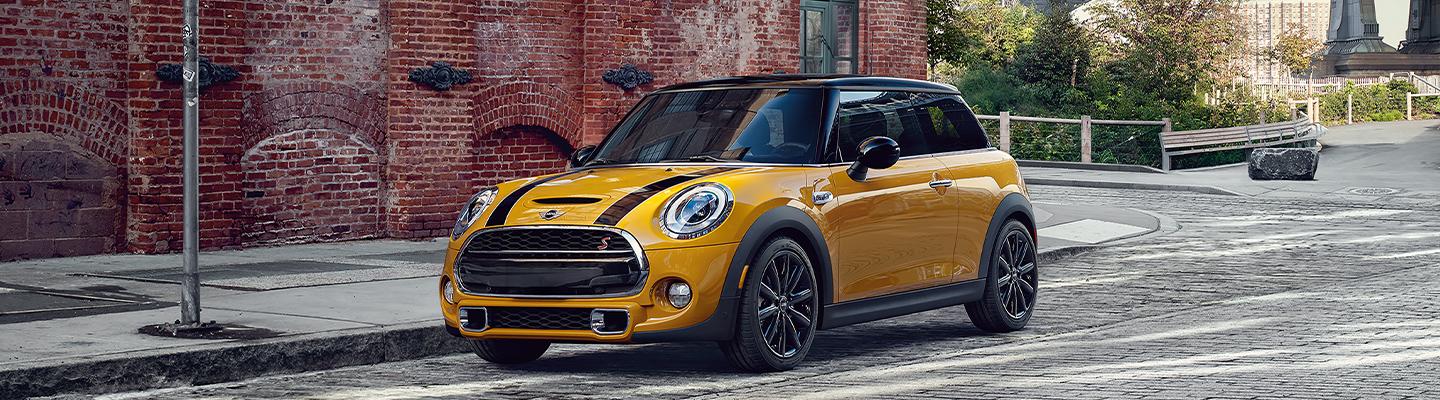 Side view of a 2021 MINI Hardtop 2 Door in motion