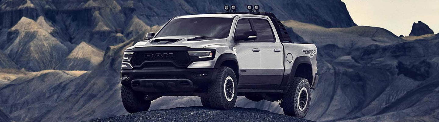 White 2021 RAM 1500 TRX on a rock in the desert 
