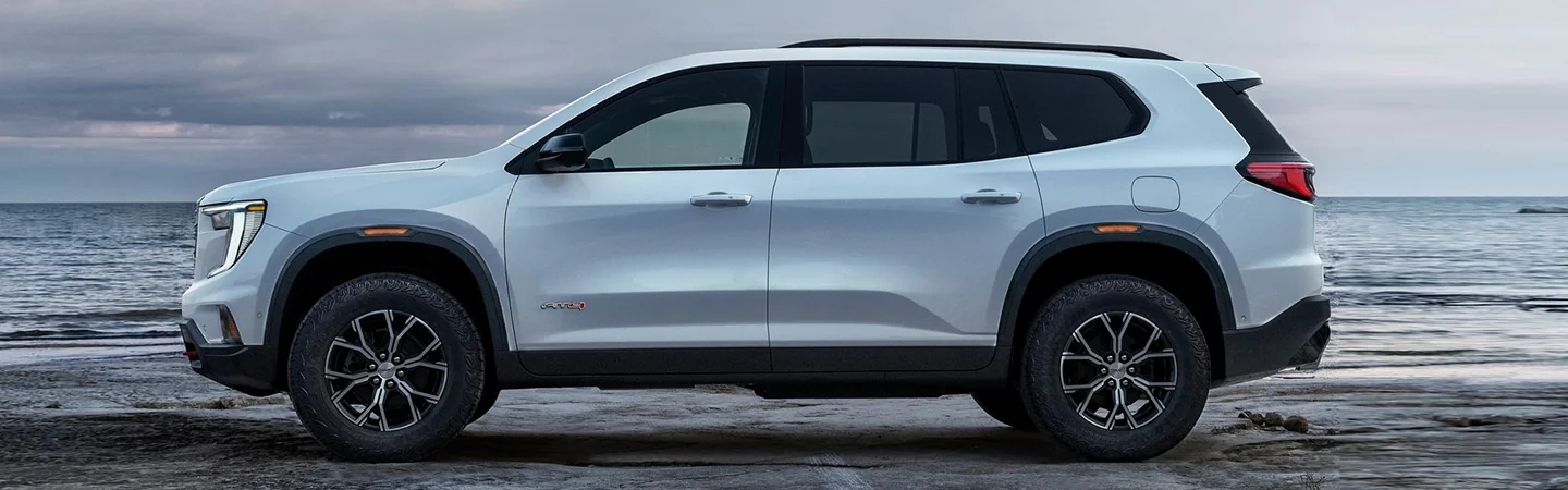 2024 GMC Acadia Denali side front in white 