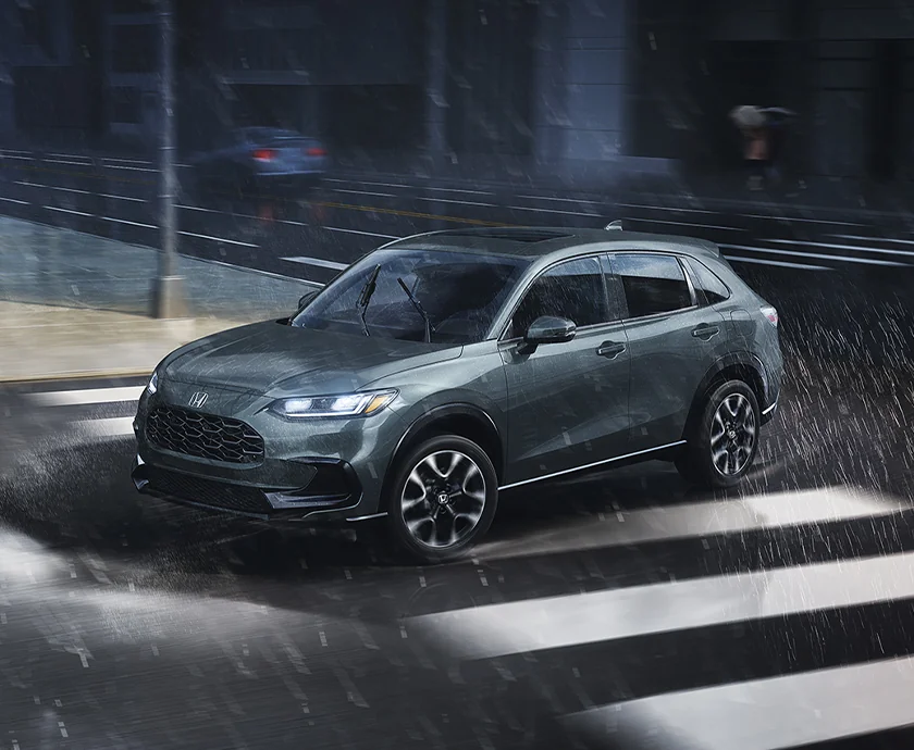view of the 2027 Honda HR-V exterior driving in rain in city