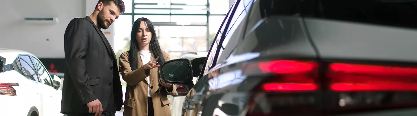 Car salesman showing a customer a new Lexus