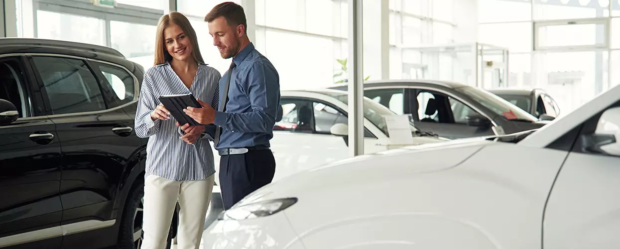Folks new car shopping in car showroom