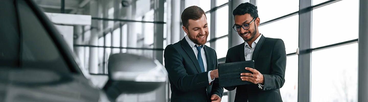 two salesman looking over tablet of information