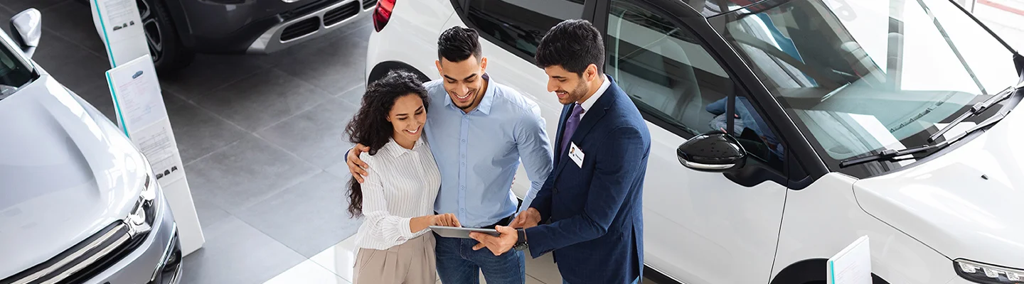 car salesman with couple
