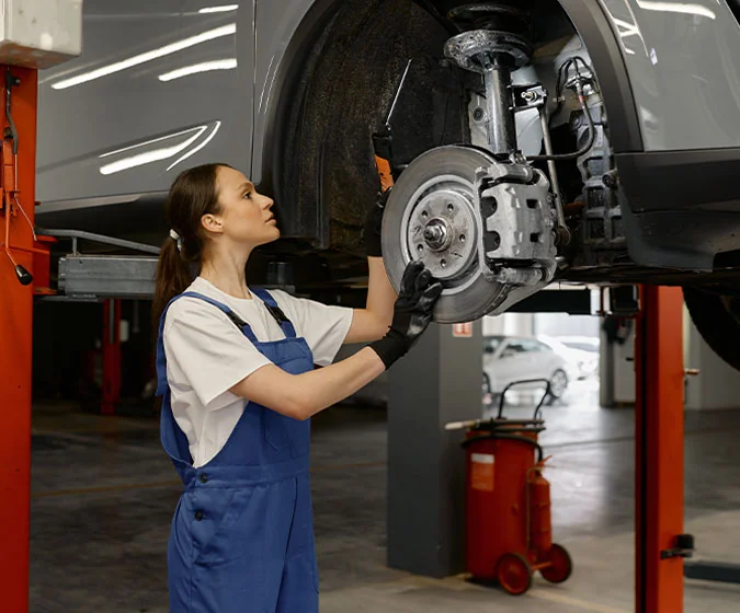 Service tech working on a cars brakes