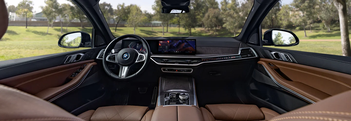 Interior view of a the front seat and dashboard in a 2026 BMW X5