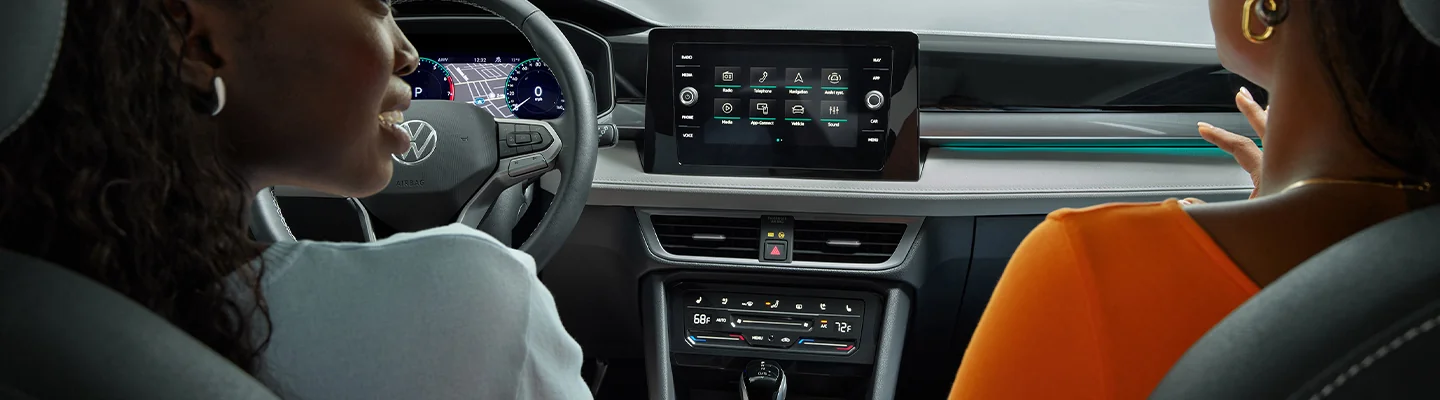 People sitting in a 2025 Volkswagen Taos talking