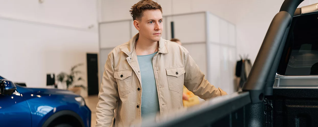 Customer looking at a new vehicle at a car dealership