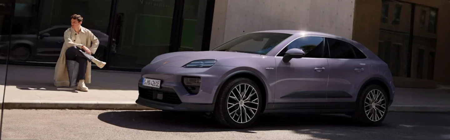 Purple 2025 Porsche Macan parked in the city