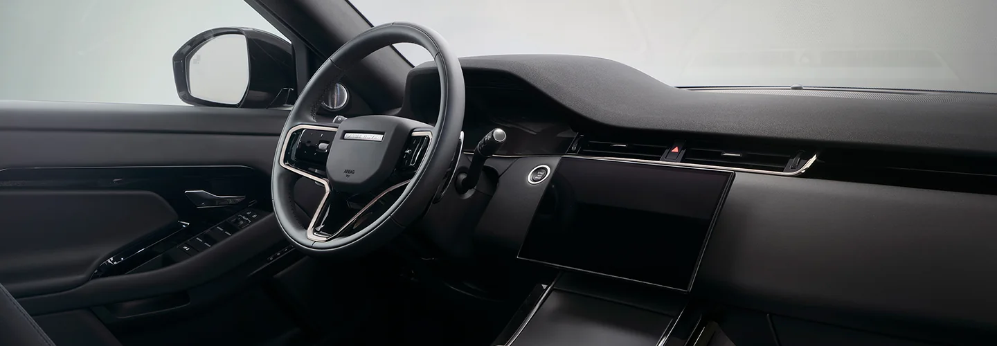 Interior view of the dashboard and tech in a 2026 Range Rover Evoque