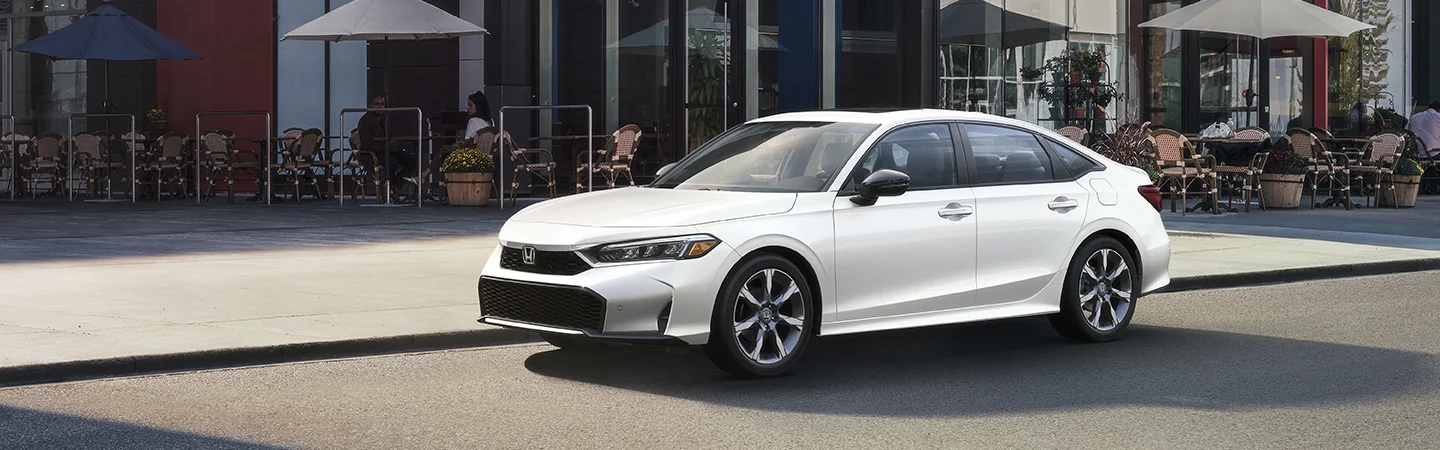 A white 2026 Honda Civic parked on a city street