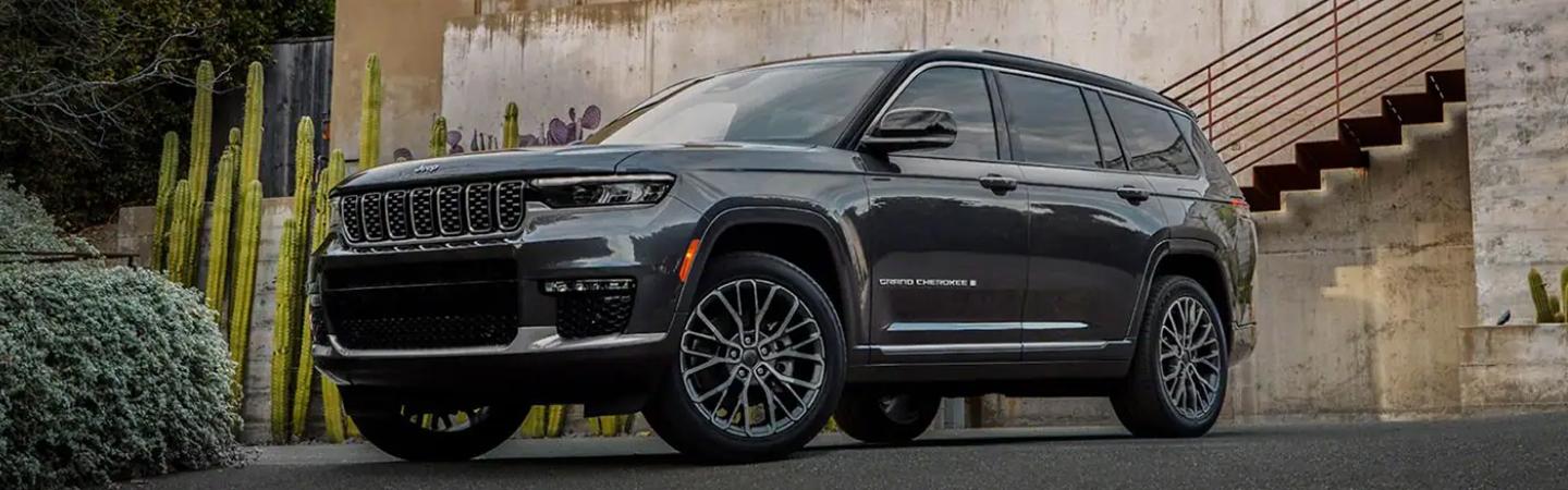 2022 Jeep Grand Cherokee L parked by wall of cactus