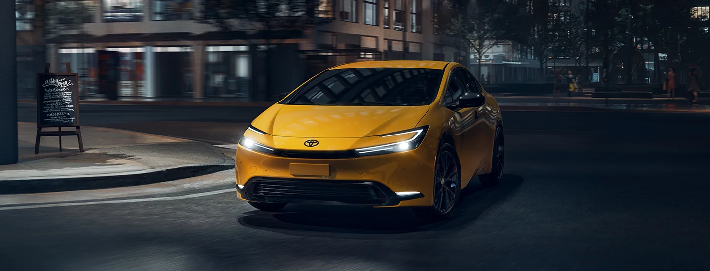 yellow 2025 Toyota Prius at night