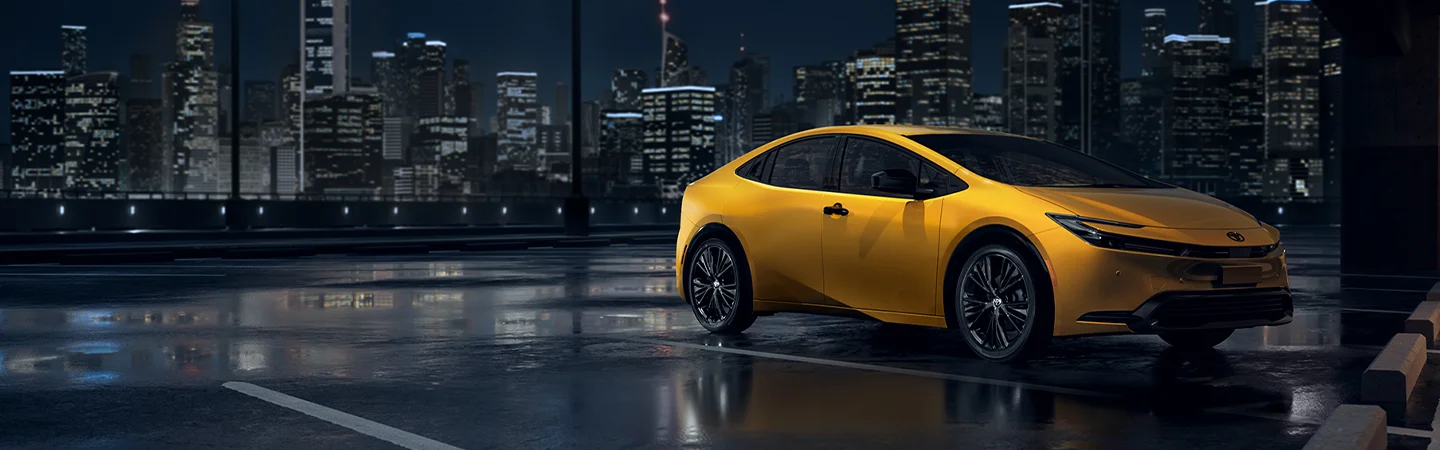 yellow 2025 Toyota Prius with cityscape in back