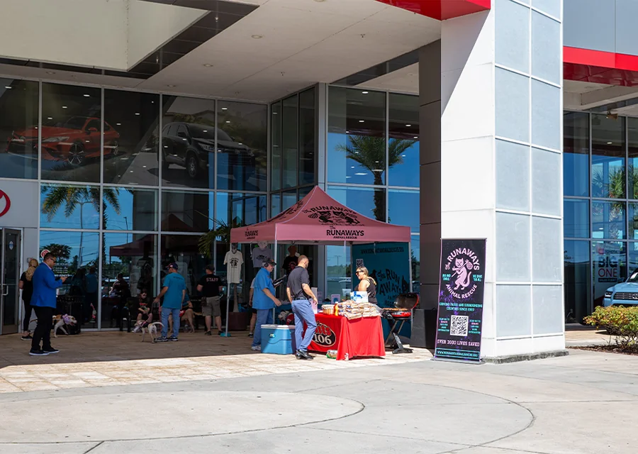 Out in front of dealership showing the greeting tent for the Pet Adoption Event in partnership with Hits 106 and Runaways Animal Rescue.