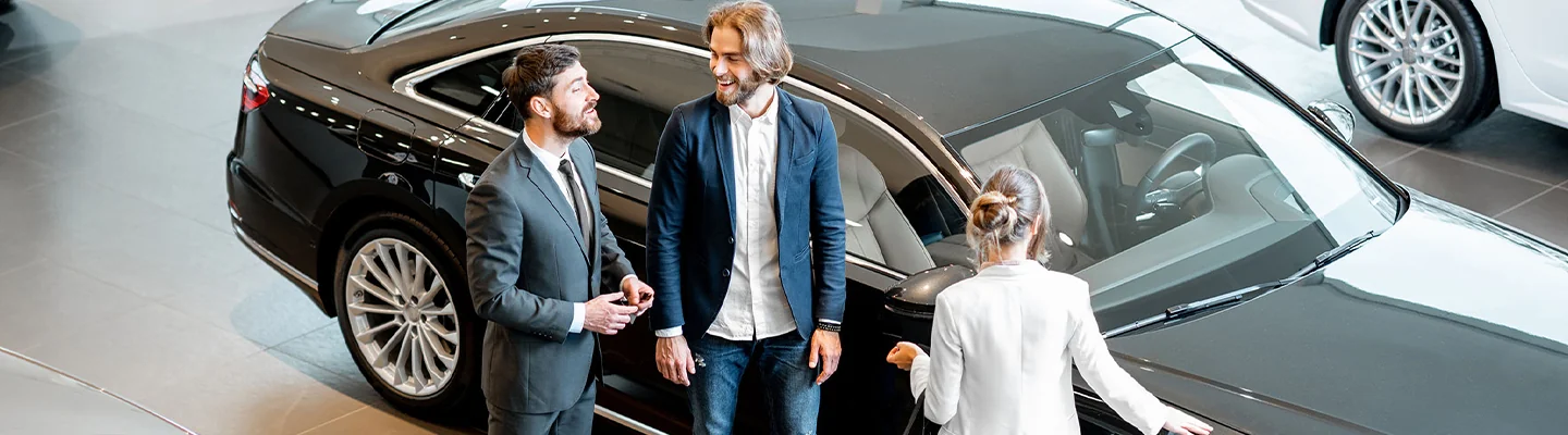 People looking at a BMW in a dealership