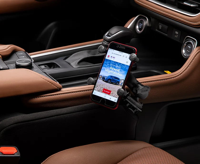 Interior view of the center consol with a phone in a 2026 Toyota Grand Highlander