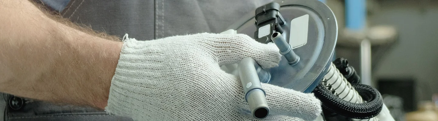 auto mechanic's hands working with a car part