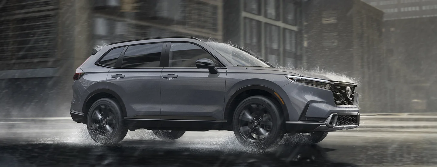 2026 Honda CR-V Hybrid driving in the city in the rain
