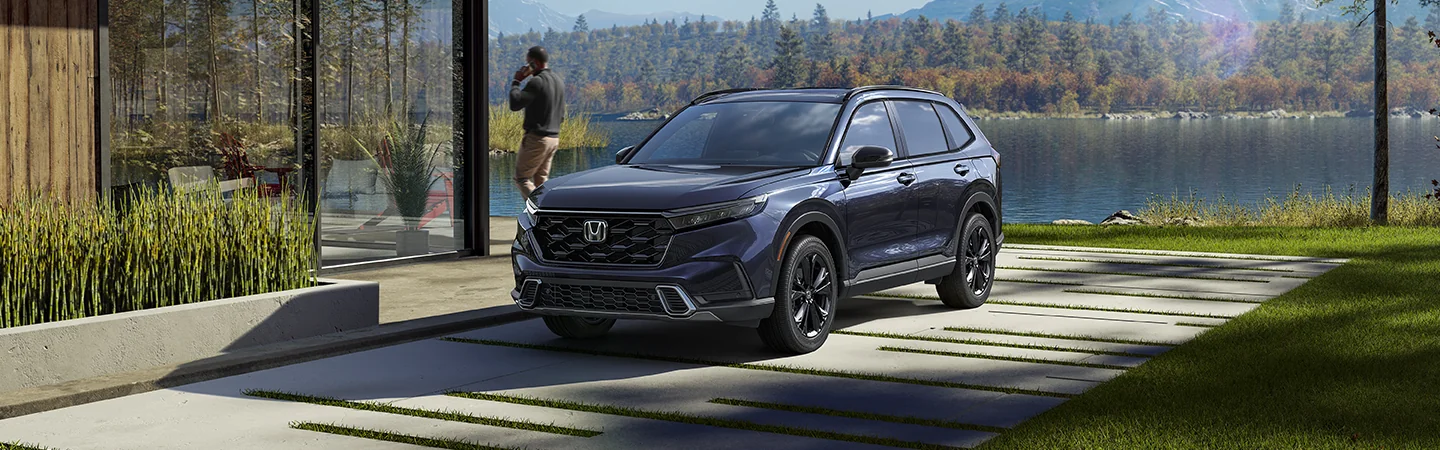Front view of the 2026 Honda CR-V Hybrid parked in front of a lake