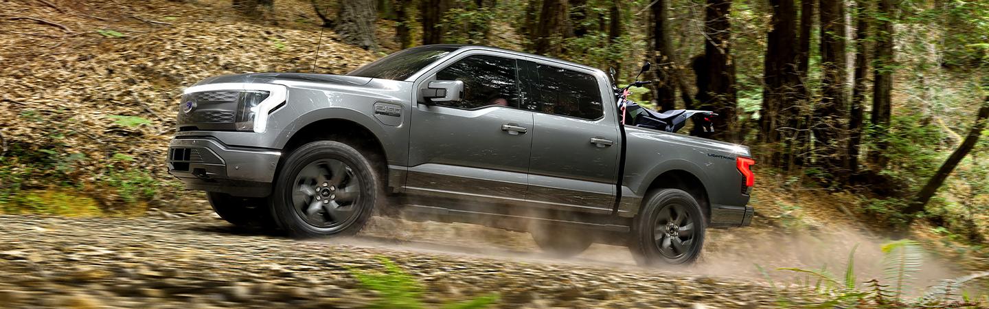 Grey 2022 Ford F-150 Lightning on Dirt Road