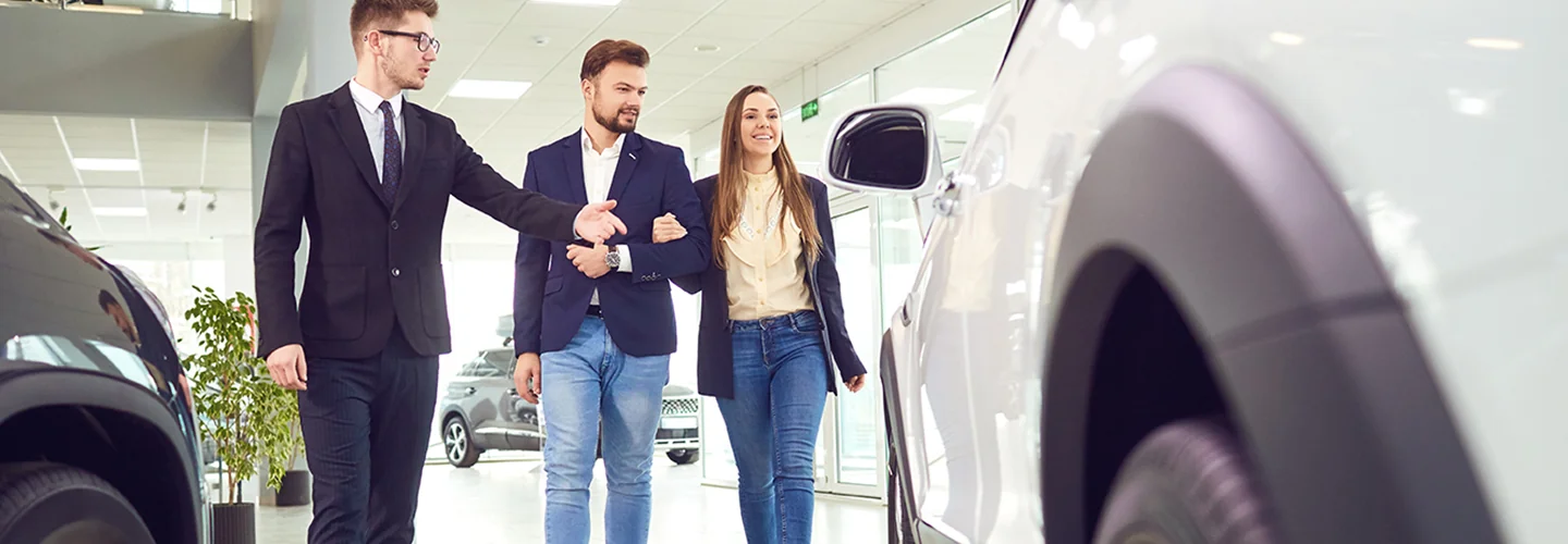 Salesman showing a BMW to customers