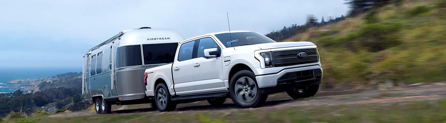 White 2022 Ford F-150 towing trailer