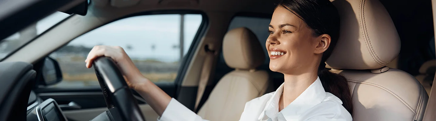 a person driving a car looking very happy with the Fuel-Efficient CDJR Model