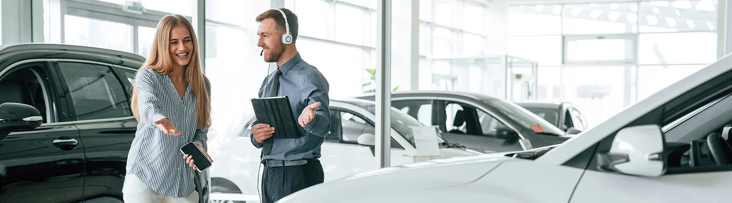 Sales person showing customer new cars