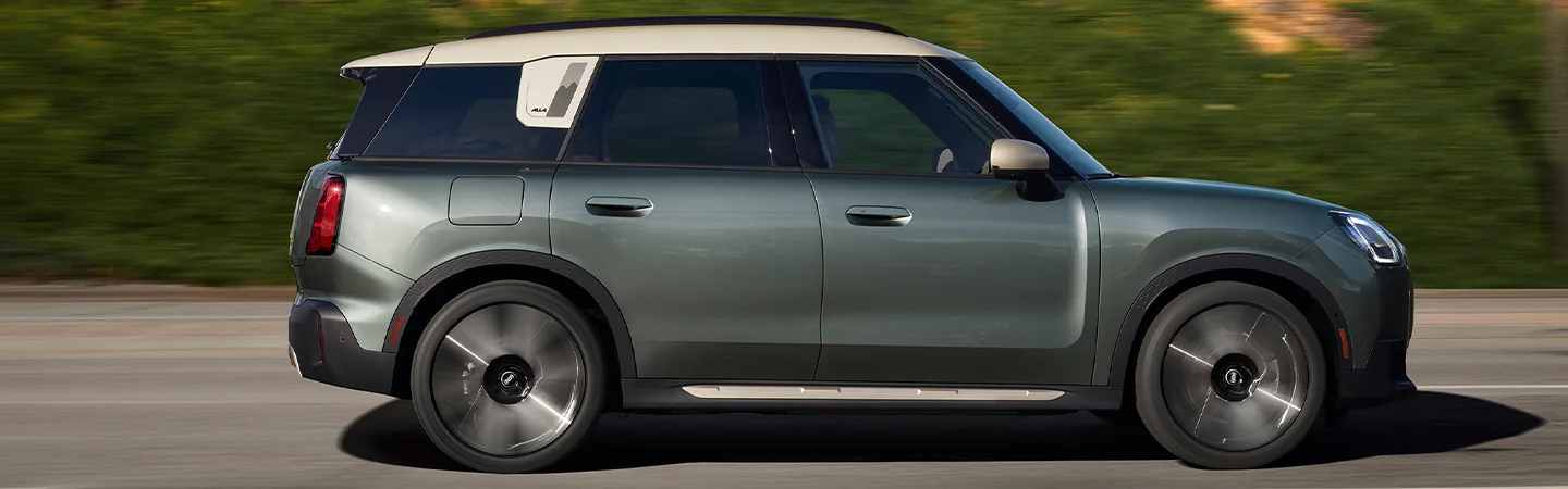 Side view of a 2025 MINI Countryman SE ALL4 driving on the road