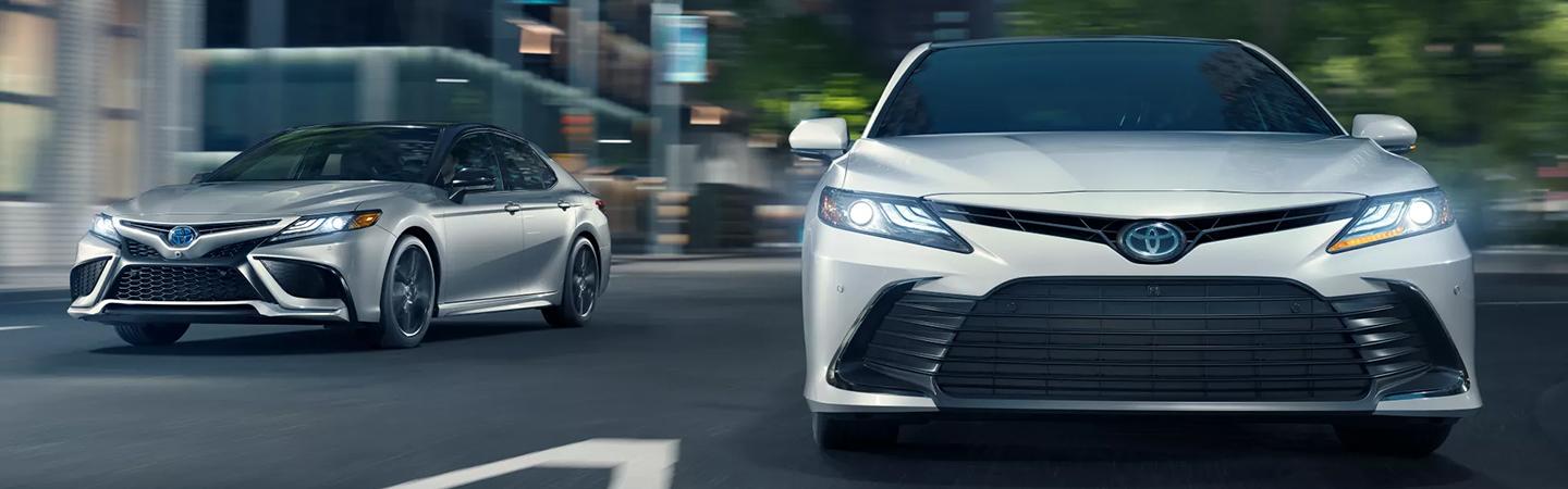 2 2021 Toyota Camrys driving in city