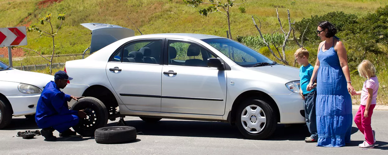Service mechanic changing the tire of a car