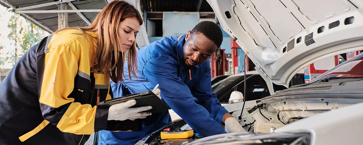 technicians repairing engine