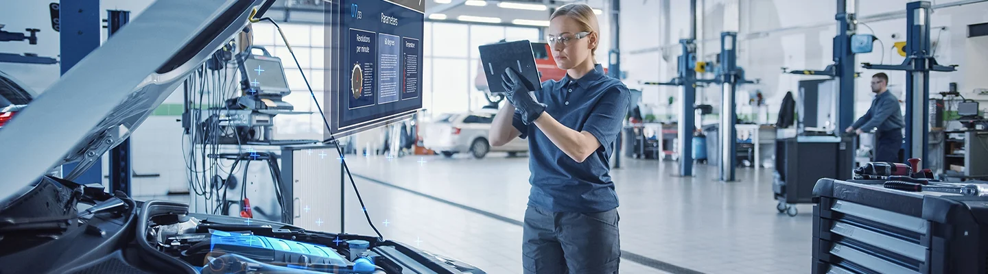 auto mechanic checking car eadings in service bay