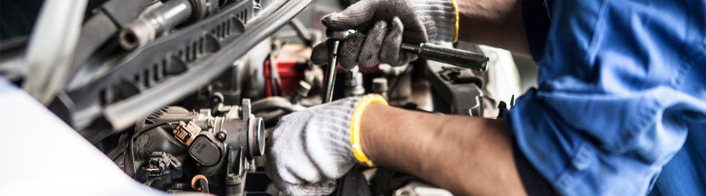 tech working on engine in Mercedes-Benz