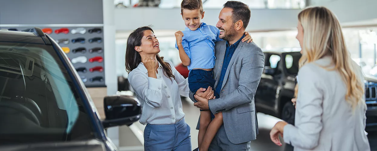 Family in a Toyota dealership looking at new vehicles