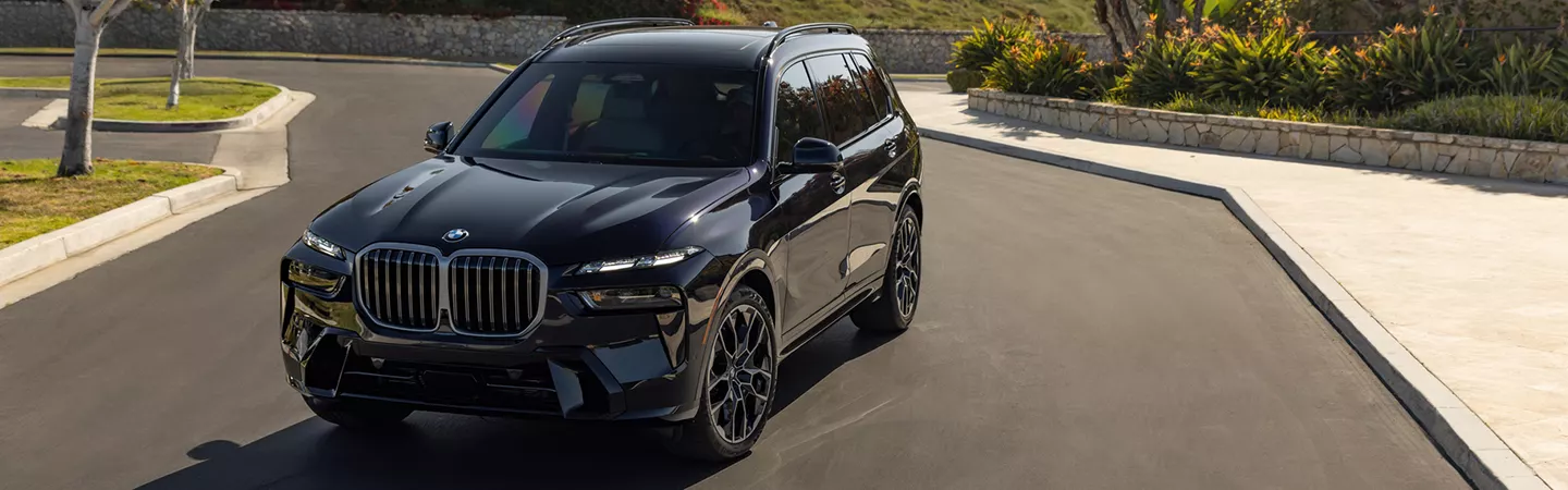 Front view of a 2026 BMW X7 parked on a neighborhood street
