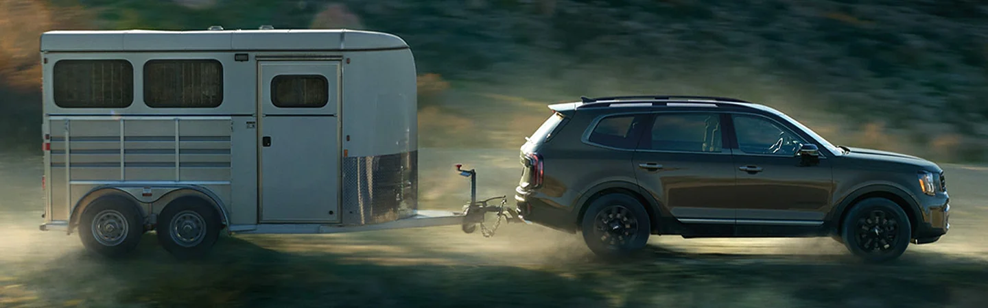 AComparison: 2024 Kia Telluride vs. Ford ExplorerLT side front in brown