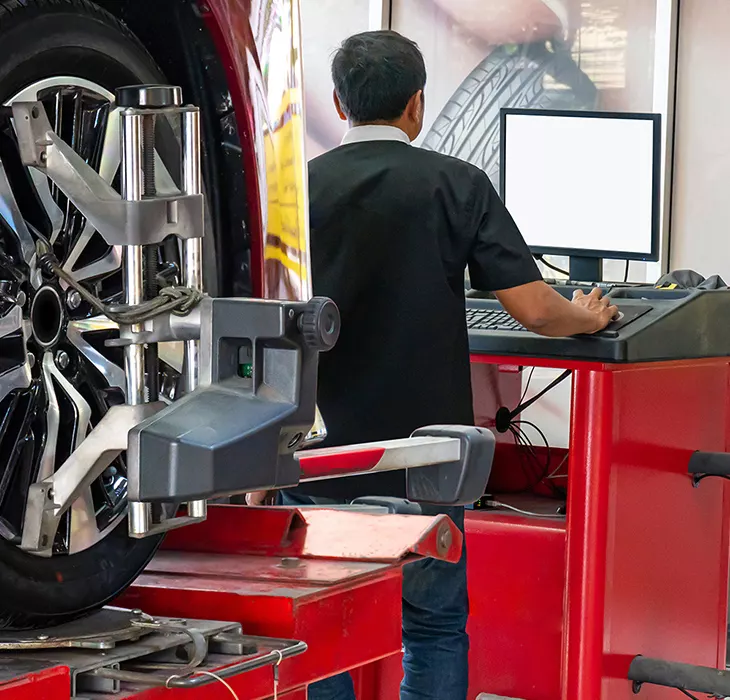 Technician servicing a vehicle