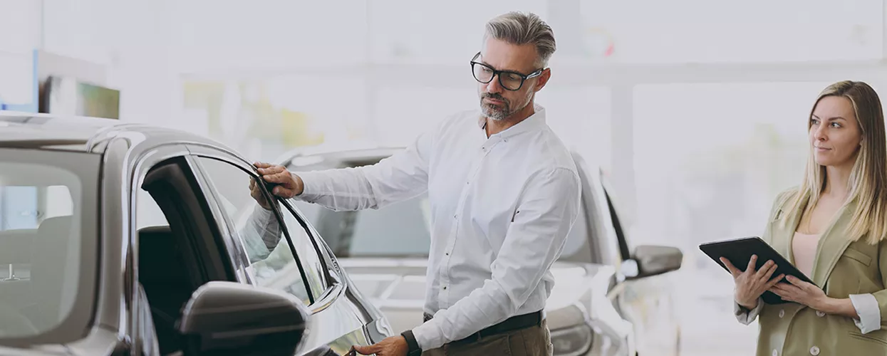 Customer looking at a vehicle in a car dealership