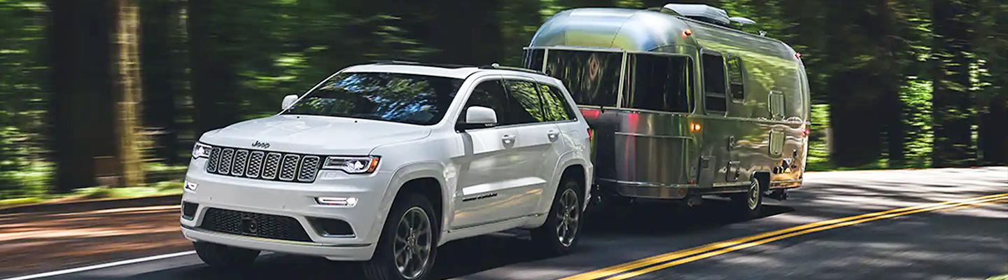 2022 Jeep Grand Cherokee L in motion towing an RV side view